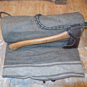 Wool blanket with ax tucked into the roll